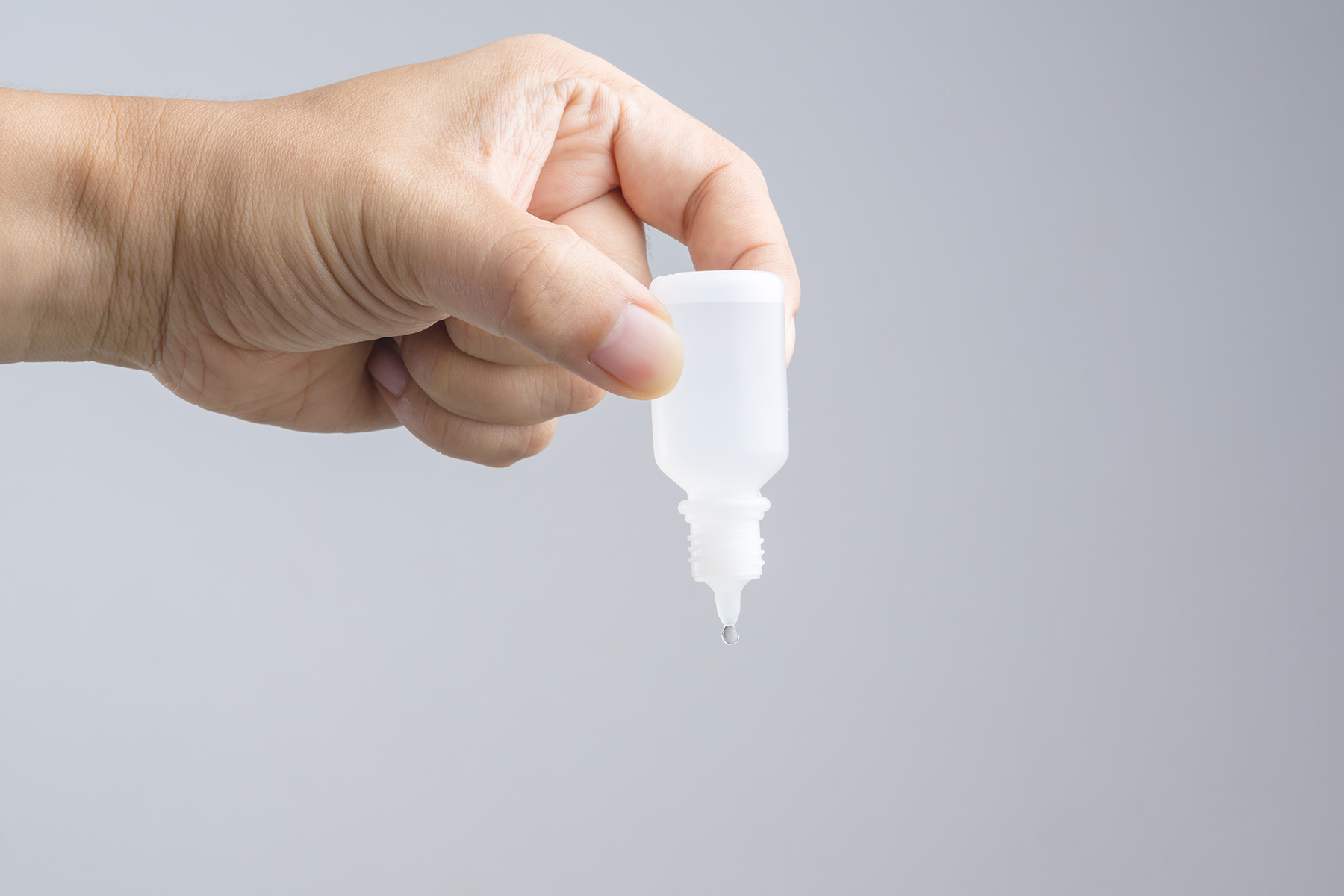 A close up of an eye drop bottle.
