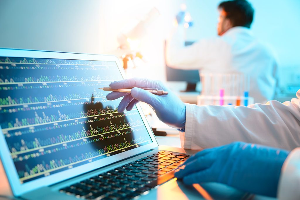 Close up of a hand wearing a surgical glove, analyzing a chart.